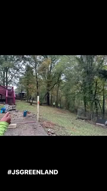 Fence installation project in progress on a wooded property