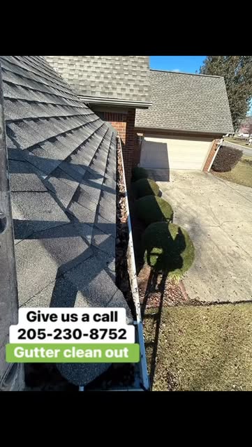 Professional gutter cleaning on a residential roof