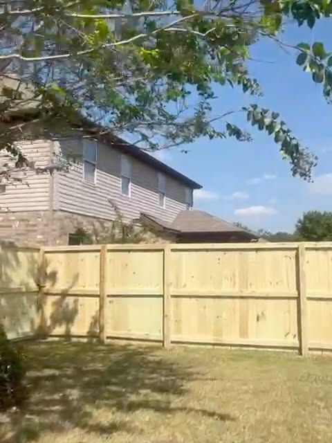 Completed wooden privacy fence around a backyard