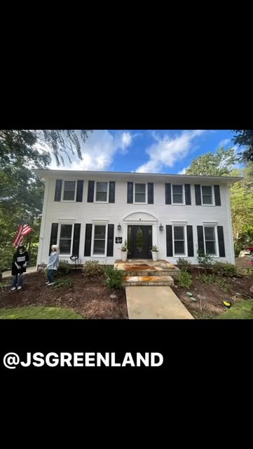 Finished front-yard landscaping with fresh mulch and a clean entrance path