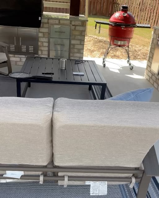 Covered patio with stone outdoor kitchen and grill